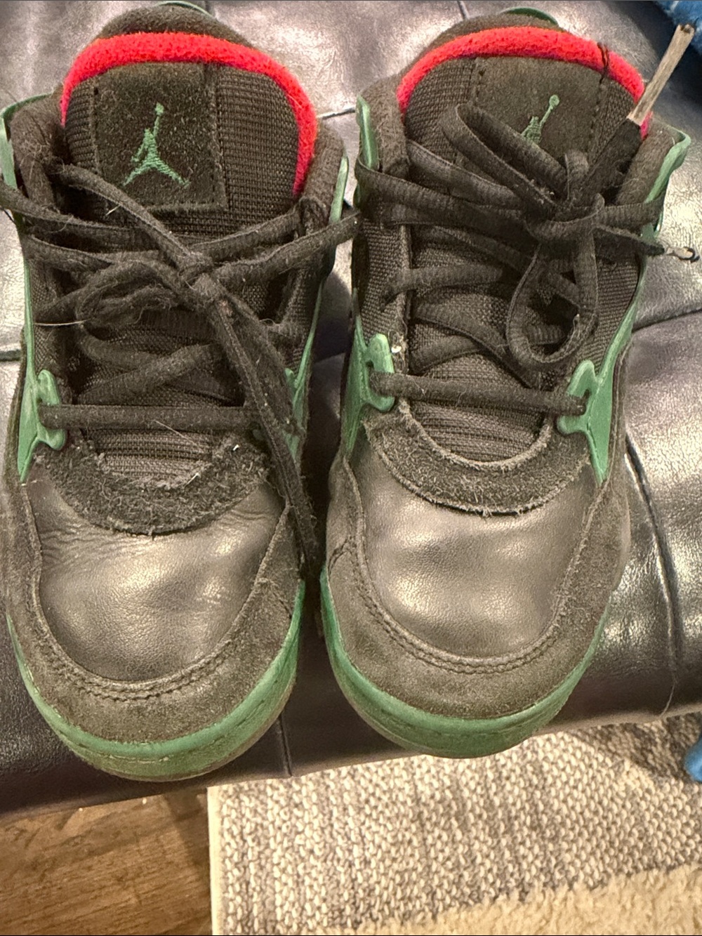 Jordan Kids Black Sneakers with Green Accents and Red Lining
